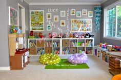 a child's playroom with toys and bookshelves