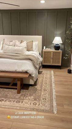 a large bed sitting on top of a hard wood floor next to a wooden table