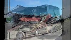 an old semi truck is parked on the side of the road in front of a mountain