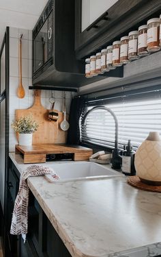 the kitchen counter is clean and ready to be used as a storage area for spices