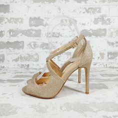 a pair of women's high heeled shoes against a white brick wall background