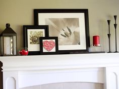 a mantle with pictures and candles on it