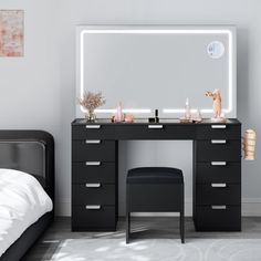 a bedroom with a bed, desk and mirror on it's side in front of a white wall