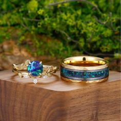 three different rings sitting on top of a wooden table