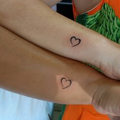 two people with matching tattoos on their arms