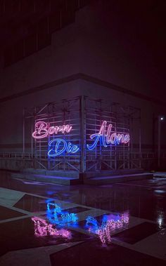 neon signs are lit up on the side of a building in front of a black and white checkered floor