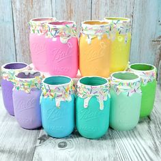 colorful painted mason jars with sprinkles on them