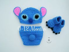 a blue crocheted hat and booties with ears