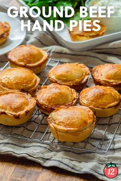 there are many small pies on the cooling rack with text overlay that says ground beef hand pies