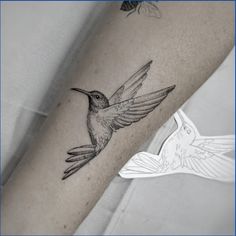 a hummingbird tattoo on the right arm