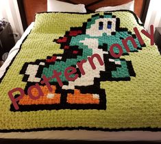 a bed with a blanket made to look like an old video game character