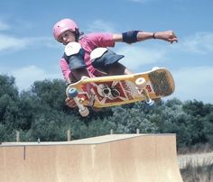 a person on a skateboard in the air doing a trick at a skate park