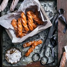 an overhead view of doughnuts on a tray with scissors and other baking utensils