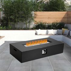 an outdoor fire pit sitting on top of a patio