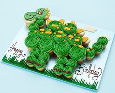 a birthday card with cupcakes shaped like a dinosaur