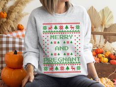 Merry and Pregnant Ugly Christmas Sweater Pregnancy Announcement Sweatshirt - the perfect pregnancy reveal this holiday season! This ugly Christmas sweater design has a special twist - a big 'pregnancy' announcement in the center. This Ugly Christmas Sweater style sweatshirt will get a laugh (and some congratulatory hugs) from your family and friends. So whether you're celebrating your first Christmas as a family or adding another little one to the mix, do it in style with this fun and festive p