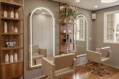 a salon room with chairs, mirrors and shelves