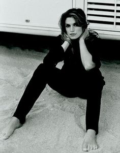 a woman sitting on the ground in front of a microwave