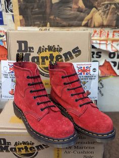 These are a very rare and original Made in England Dr Martens boots. They were made in the 1990s at their original factory in Northampton, England. They are a 6 hole boot finished in a super soft Red Suede leather. An unusual colour and finish for sure. They have trademark cushioned sole unit and yellow stitch welt. They are a UK size 6, EUR 39, ladies US 8 Retro High-top Winter Boots, Retro Lace-up Winter Boots, Red Sole Lace-up Boots For Streetwear, Classic Red High-top Boots, Vintage Work Boots With Rubber Sole For Fall, Retro Boots With Rubber Sole And Round Toe, Vintage Moto Boots With Steel Toe, Vintage Boots With Rubber Sole For Fall, Red Casual Boots With Vibram Sole