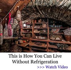 an old fashioned kitchen with wooden shelves filled with food and wine bottles hanging from the ceiling