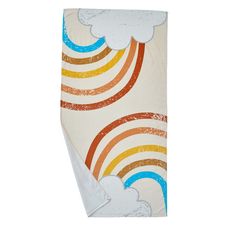 a white towel with rainbows and clouds painted on it's side, in front of a white background