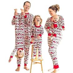 three people in matching christmas pajamas are standing on a chair and one person is upside down