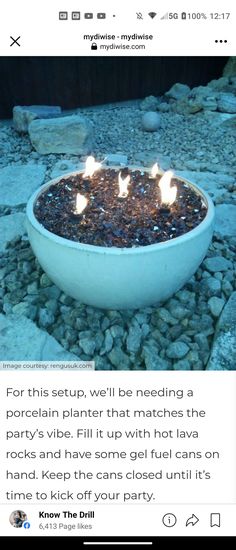 a bowl filled with fire sitting on top of rocks