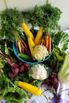 a bowl filled with lots of different types of veggies on top of a table