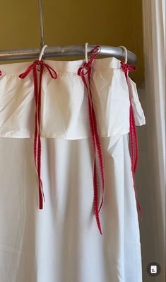 a white curtain with red bows hanging from it