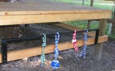 there are many small blue and red objects on the ground in front of a bench