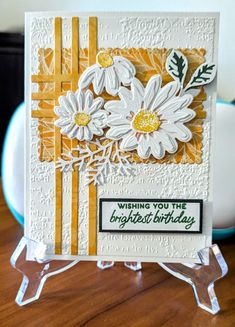 a card with white daisies on it and the words wishing you're the brightest birthday