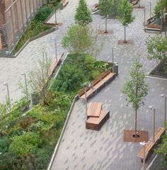 several wooden benches sitting in the middle of a courtyard