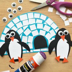 penguin paper cut out with glue and scissors