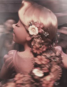 a black and white photo of a woman with flowers in her hair