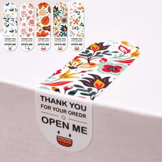 an open box with flowers on it and the words thank you for your order written below