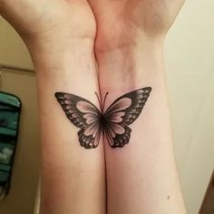 two hands with tattoos on them, one has a butterfly