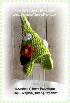 a crocheted green hat with flowers on it