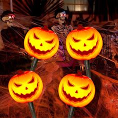 three jack o lantern pumpkins with faces on them