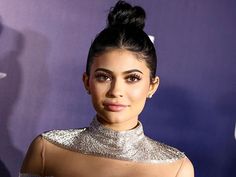 an image of a woman that is on the red carpet with her hair in a bun