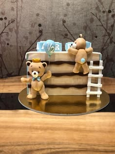 two teddy bears sitting on top of a cake that is shaped like a ladder to the sky