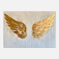 two golden wings on a white background