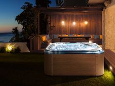 a hot tub sitting on top of a lush green field