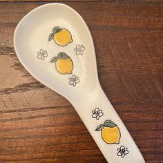 a ceramic spoon with lemons painted on it