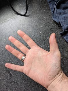 a person's hand with two rings on it