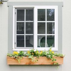 a window box with flowers in it on the side of a building