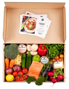 an open box filled with assorted fresh vegetables