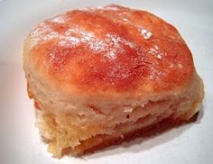 a close up of a piece of food on a white plate with some powdered sugar