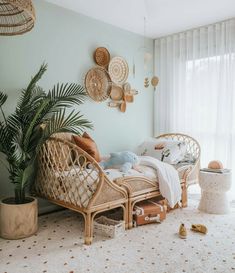 a living room with wicker furniture and plants