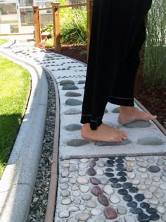 a person standing on top of a stepping stone walkway