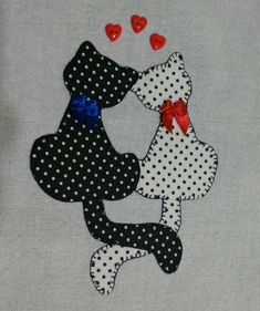 two dogs hugging each other with hearts in the air on a white shirt that has black and white polka dots